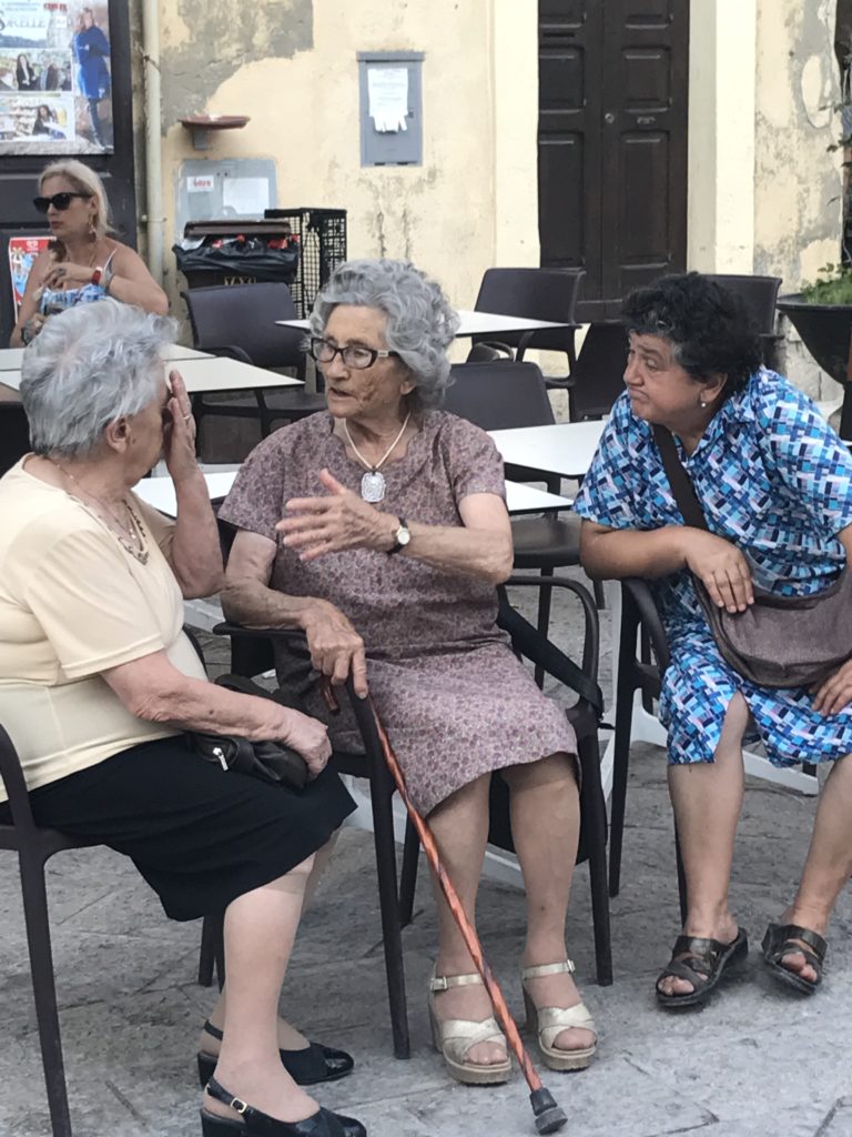 If you want people to tell you the truth, you need to listen well and you need their trust. Like these lifelong friends in an Italian Piazza.